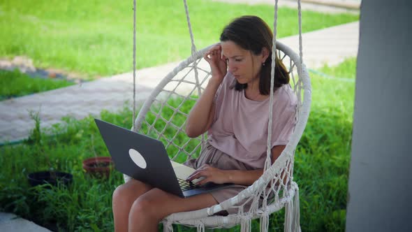 Woman Work In Garden Swing Chair alt