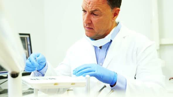 Dentist checking tools in dental clinic alt