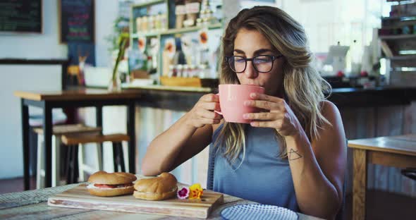 Young Woman Drinking Coffee alt