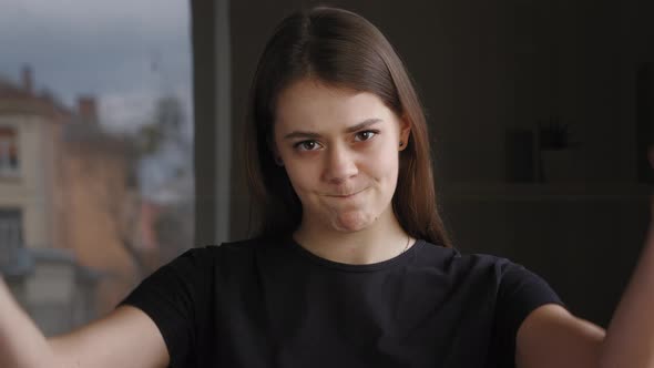Young Brunette Caucasian Girl Unsatisfied Upset Woman Standing Indoor Posing Looking at Camera alt