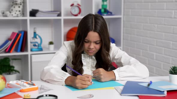 Serious Female Student in School Uniform Writing Trying to Solve Math Problem Study alt