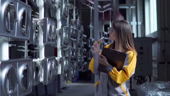 A Young Pretty White Woman Works in the Paint Shop of the Plant She Checks the Unpainted Metall alt