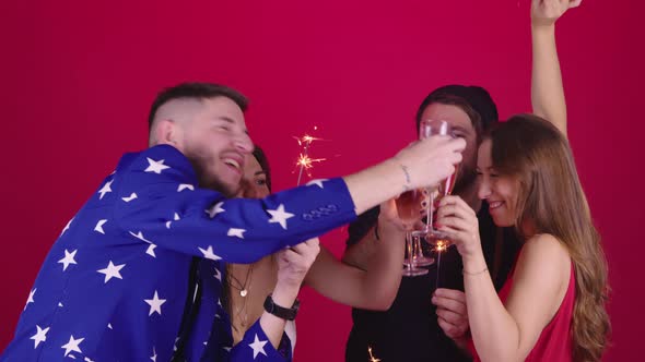 Group of Young People Celebrating Christmas, New Year's Eve on Red Background