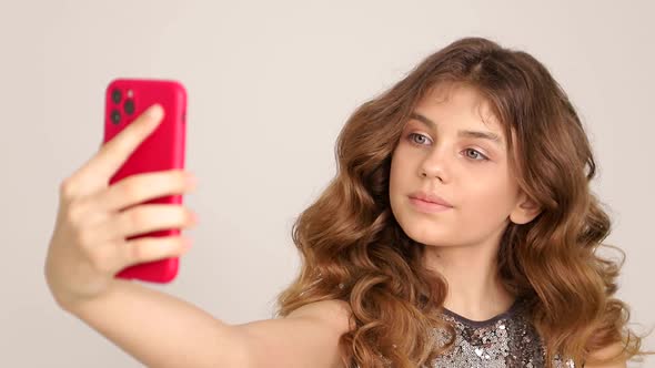 Portrait of a Smiling Girl Taking a Selfie Photo alt
