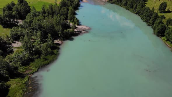 Aerial View Of Calm Turquoise Lake Water In Klammsee, Kaprun, Austria - drone shot alt