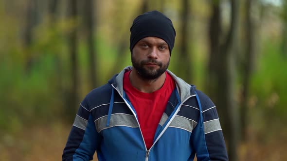 Portrait of a Smiling Handsome Middle Aged Man in Nature, Slow Motion. Mature Caucasian Man Laughs alt