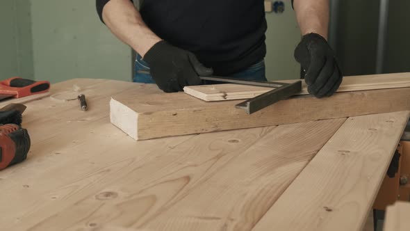 The Builder Measures the Angle with a Construction Tool and Writes with a Pen