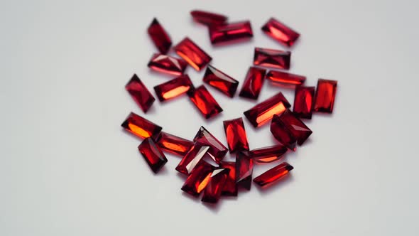 Natural Red Garnet Gemstone on the White Background on the Turning Table