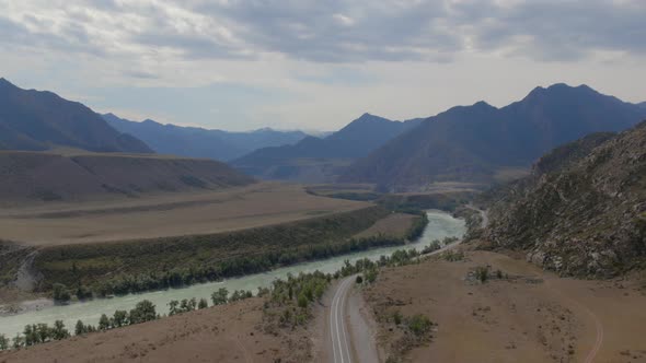 Mountains valley of Altai with blue Katun river under dramatic sky alt