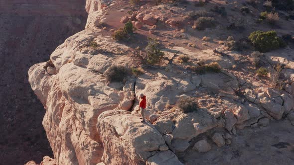 Aerial shot of a hiker at the the edge of Cedar Mesa in Utah alt