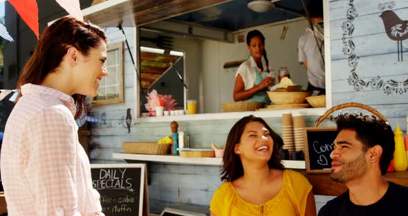 Friends interacting while having snacks alt