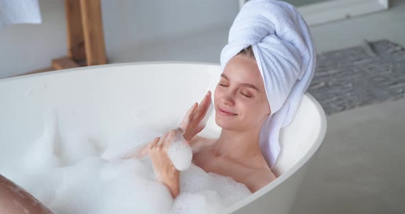 Woman Taking A Bubble Bath At Her Home