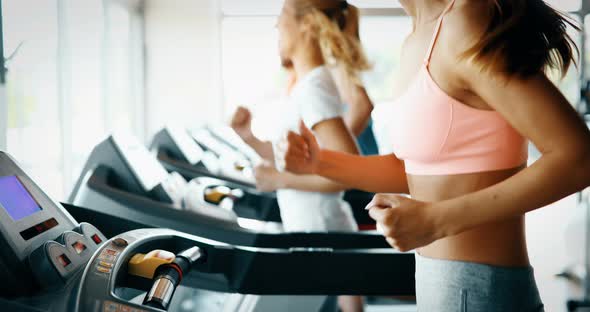Group of Friends Exercising on Treadmill Machine