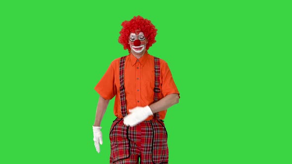 Clown in a Red Outfit Walking Like a Robot on a Green Screen Chroma Key alt