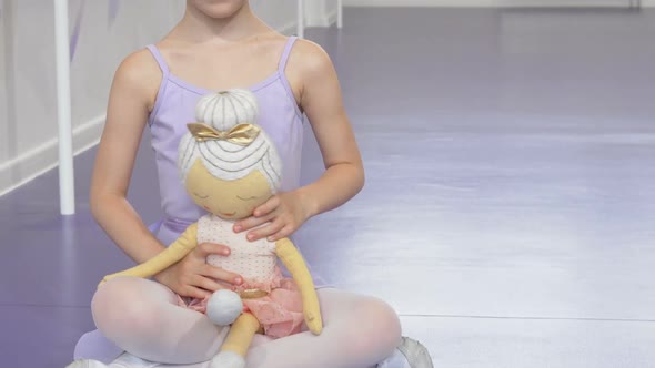 Cute Happy Little Ballerina Girl Smiling Joyfully Holding Ballerina Doll
