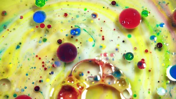 Colorful abstract bubbles and drops on the yellow and white water surface