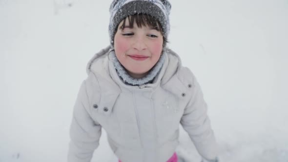 Happy Cute Little Girl Making Snow Angel alt