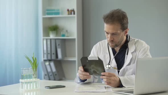 Plastic Surgeon Sitting at Table and Looking at Nasal Bones X-Ray, Health Care alt