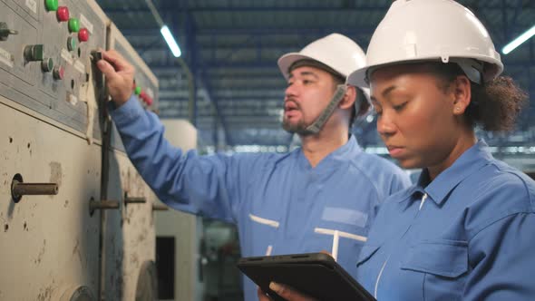Industry engineer teams inspect machine control panels in manufacturing factory. alt