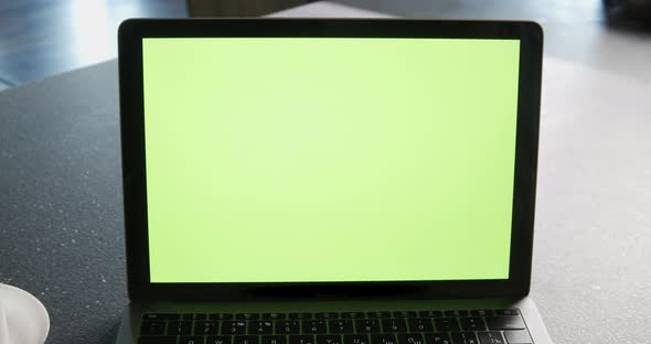 Modern Laptop with Mock Up Chroma Key Green Screen on Table