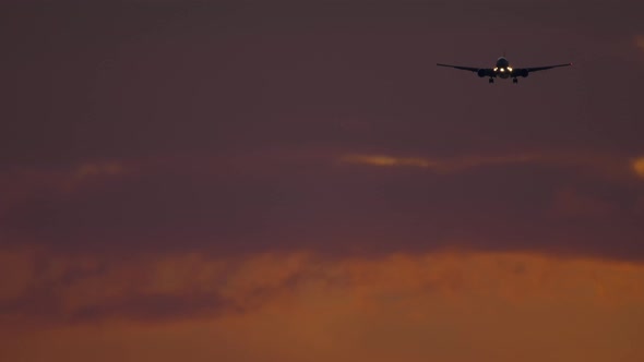 Airliner Approaching the Airport Over Ocean in Dusky Sky. alt