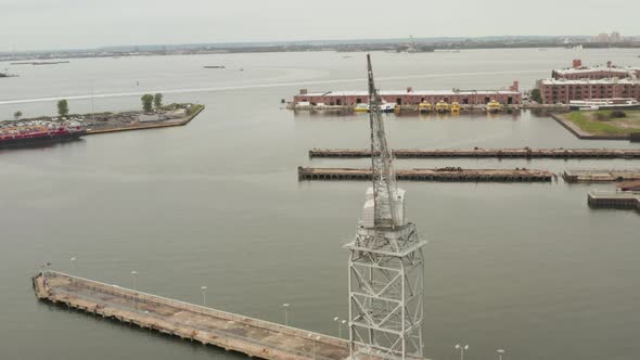 Circling Industrial Crane in Docks of New York City with Boats and River  alt