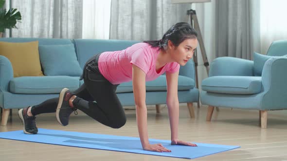 Fitness Asian Female Is Doing Mountain Climber Exercises In Her Home alt
