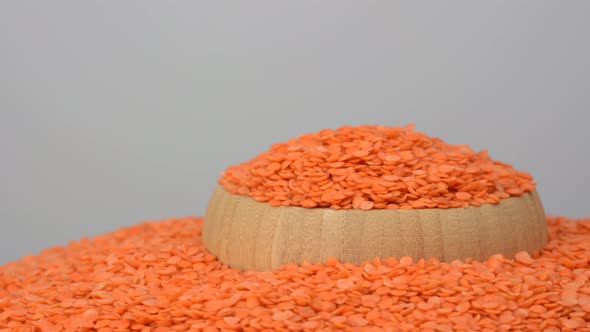 Raw organic red lentils grains on white background, close view.   alt