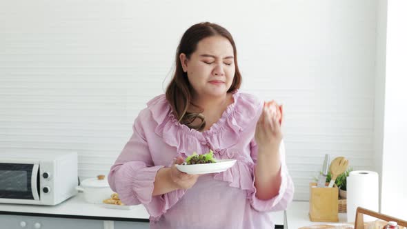Unhappy Fat woman preparing salads for dieting weight loss.