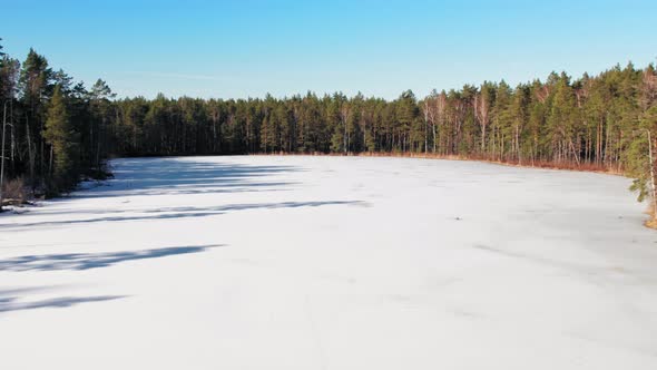 View from the top of the Latvian lake in the Jurmala region, the lake is icy and frozen covered