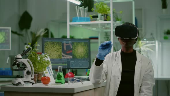 African Biologist Researcher with Virtual Reality Headset Researching New Genetic Experiment alt