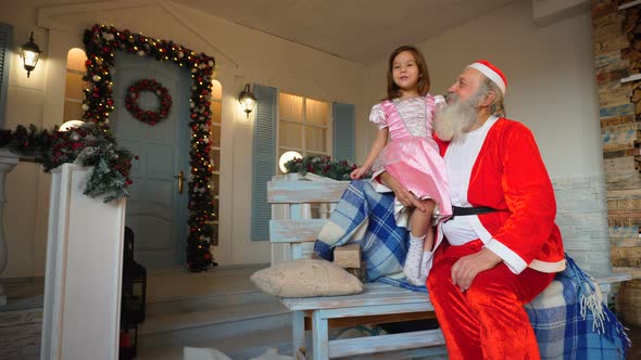 Little Girl Singing with Santa Claus.
