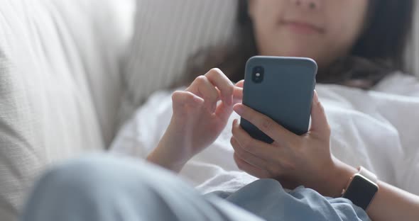 Woman use of cellphone at home alt