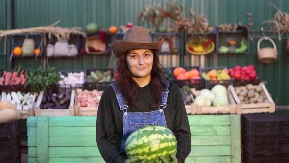 Woman Farmer (Seller) With Watermelon at the Farmer's Market.