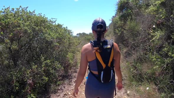 Attractive Girl Hiking up Steep Dirt trail in San Luis Obispo, CA