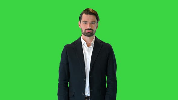 Handsome Man in a Suit Pushing Virtual Buttons Presenting Something on a Green Screen Chroma Key alt