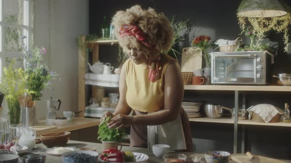 Culinary Blogger Taking Fresh Herbs for Cooking alt