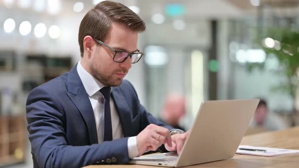 Businessman with Laptop Looking at the Camera alt