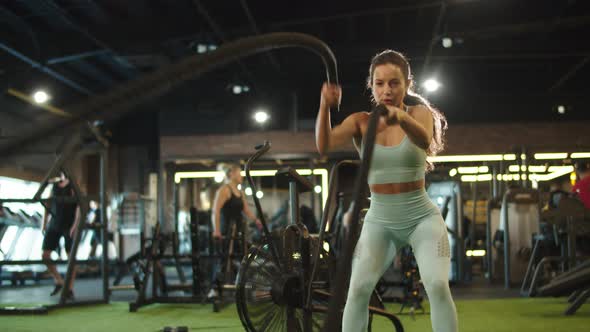 Tired Female Athlete Finishing Workout in Sport Club. Fit Girl Exercising at Gym alt