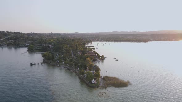 Aerial view on Manerba del Garda, Italian town by shore of lake Garda at sunrise alt