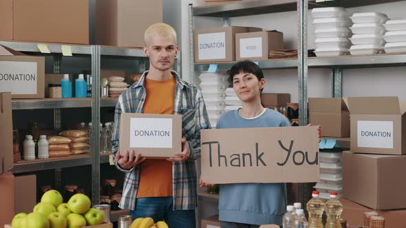 Volunteers Holding Donation Box and Thank you Banner alt
