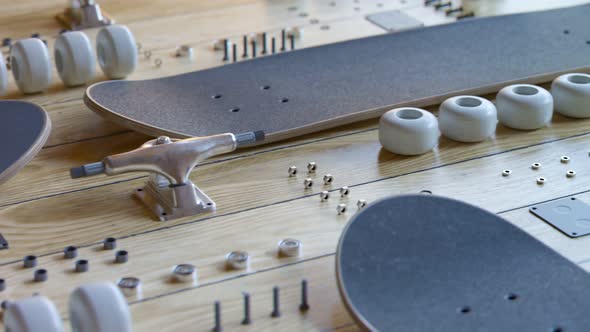 Countless disassembled skateboard parts laying on a wooden floor exposition 4KHD alt