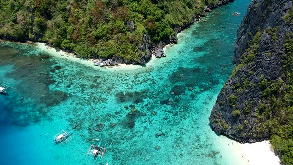 Aerial of white sand beach on Shimizu island beach El Nido, Palawan, Philippines alt