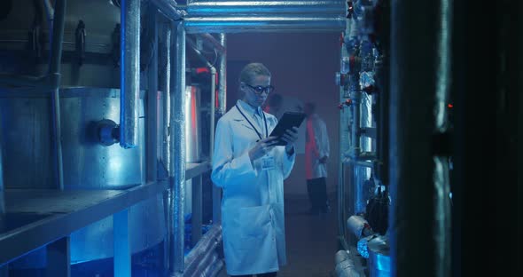 Female Scientist Checking Equipment alt