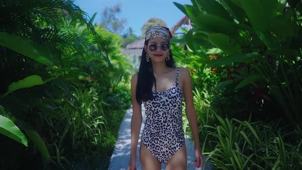 Asian Girl In Swimming Suit Walking Alone In Resort On Sunny Day in Slow Motion