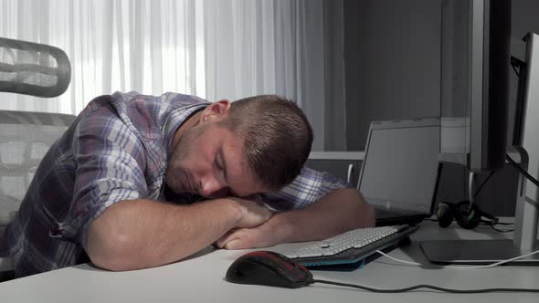 Man Sleeping on His Desk After Finishing Working on the Computer alt
