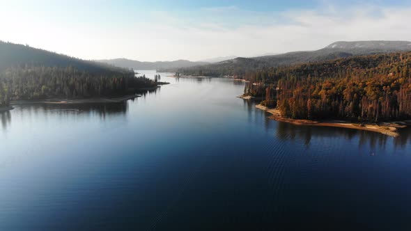 Aerial shot of beautiful blue alpine lake in late afternoon. alt