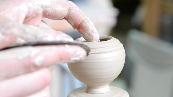 Making Lines on a Small Clay Pot Closeup alt