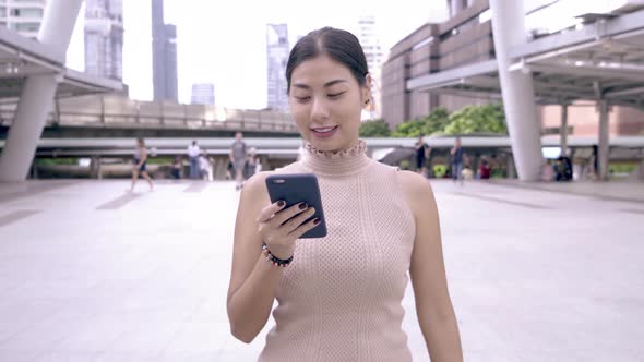 Asian Girl Using Smartphone App