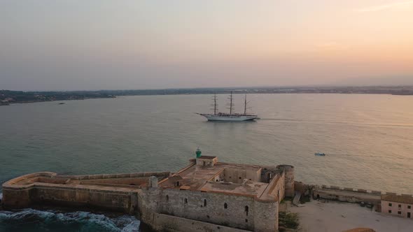 A Bird's Eye View of Ortigia Island at Sunset, Sailing Ship Out of the Bay, Sicily